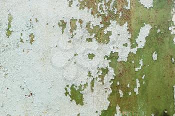 Old weathered green peeling paint texture. Background of old paint with cracks and rust.