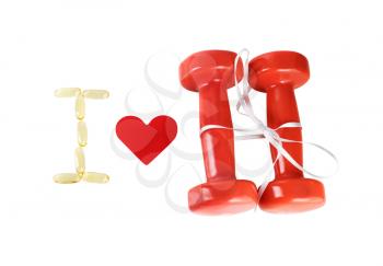 I love fitness. Still life with a heart and dumbbells tied with satin ribbon on white background. Isolated with clipping path. Top view.