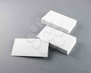 Photo of blank business cards with soft shadows on gray background. Template for branding identity.