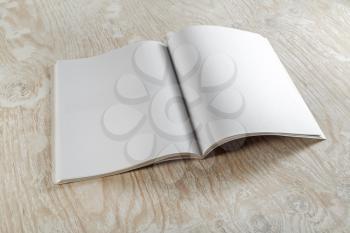 Blank booklet magazine on wooden background. Mockup for graphic designers portfolios.