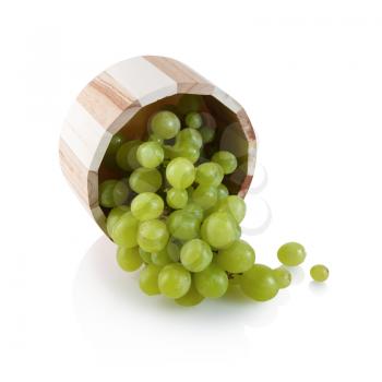 Green grapes in a small wooden tub on white background. Isolated with clipping path.