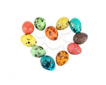 Heart of colorful painted quail eggs on a white background. Isolated with clipping path. Top view.
