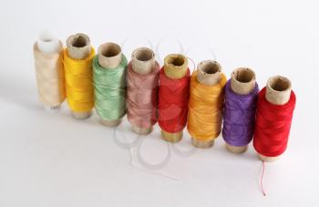 Several coils with color threads. Set of multicolored threads. Shallow depth of field.