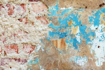 Abstract grunge background. Old vintage dirty brick wall with peeling plaster.