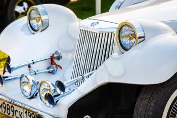 MINSK, BELARUS - MAY 07, 2016: Close-up of white Mitsuoka Le-Seyde. Vintage car. Selective focus on the headlight.