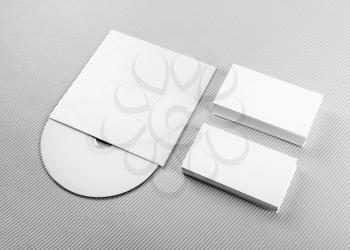 Blank business cards and CD on gray background. For design presentations and portfolios. Mockup for branding identity.