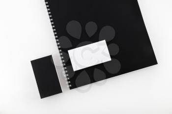 Blank black and white business cards and notebook on a spring. Mock-up for design presentations and portfolios.