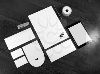 Blank stationery and corporate identity template on dark wooden background. Mock-up for branding identity. For design presentations and portfolios. Grayscale image.