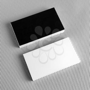 Photo of blank black and white business cards on gray background. Blank template for design presentations and portfolios. Mockup for branding identity.