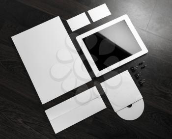Blank stationery and corporate identity template on dark wooden background.  For design presentations and portfolios.