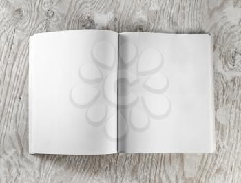 Blank opened book on wooden background. Top view.