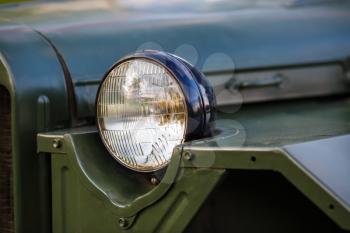 Headlight of military retro car. Selective focus.
