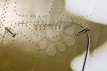Abstract painted khaki metal background with rivets.  Fragment of old military aircraft.