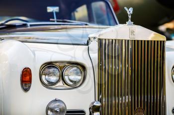 MINSK, BELARUS - MAY 07, 2016: Rolls-Royce Silver Cloud. Close-up photo of Rolls Royce. Close-up of the front part of the luxury retro car. Selective focus on the headlight.