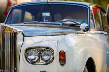 Close-up of old vintage classic car. Retro car headlight closeup. Selective focus.