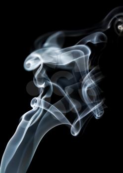 Abstract smoke swirls and waves on black background. Vertical shot.