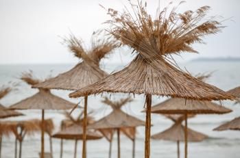 Straw beach umbrellas. Shallow depth of field.