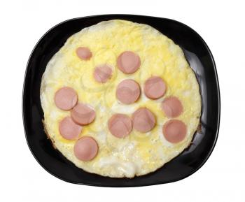 Scrambled eggs with sausages on a black plate, Clipping path.
