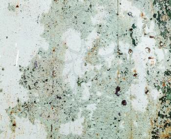 Background of old peeling paint with cracks and scratches. Weathered peeling paint texture.