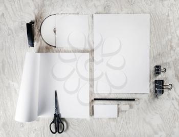 Mock up for branding identity. Photo of blank stationery and corporate identity template on light wooden table background. Responsive design mockup. Blank objects for placing your design. Top view.