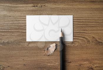Bank business card and pencil on wood table background. Responsive design mockup. Top view.