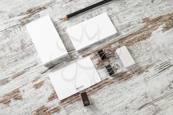 Blank stationery and corporate identity template. Business cards, badge, pencil and eraser on vintage wooden table background. Responsive design mockup.