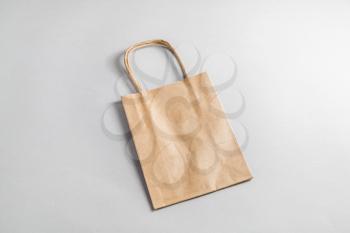 Recycled paper shopping bag on paper background. Craft paper package.