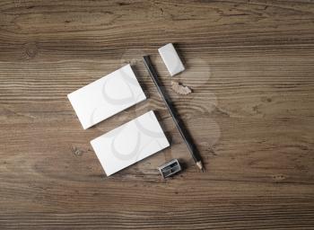 Bank business cards, pencil, eraser and sharpener on wood table background. Top view. Photo of blank stationery. Responsive design template.