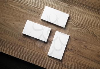 Photo of blank business cards on wooden table background. Top view.