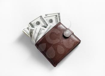 Money in a leather wallet on paper background. One hundred dollar bills. Top view.