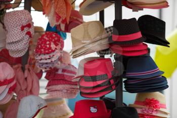 Nesebar, Bulgaria - September 02, 2014: Many variety colored hats for sale in the market. Selective focus.