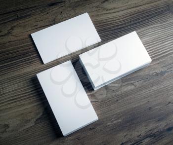 Three piles of blank business cards on wooden table background. Mockup template for branding identity. Top view.