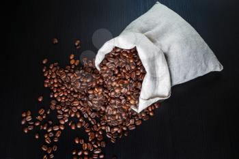 Photo of roasted coffee beans and canvas bag.