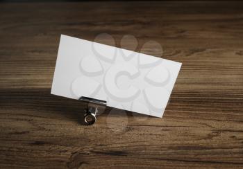 Blank business card on wood table background.
