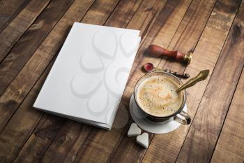 Blank book and coffee cup on vintage wood background. Responsive design template.
