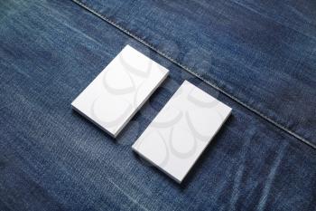 Blank white business cards on denim background. Mockup for branding identity. Template for graphic designers portfolios.
