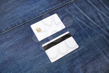 Blank chip cards on denim background. Two credit cards. Front and back view.