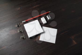Corporate stationery set on wooden background. Blank notes, pencil, eraser and sharpener.