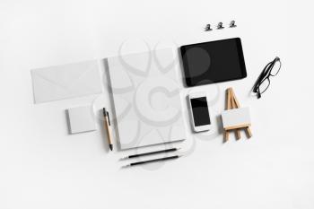 Blank corporate stationery and gadgets mockup. Brand ID elements on white paper background. Flat lay.