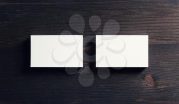 Photo of blank business cards on wooden background. Template for ID. Flat lay.