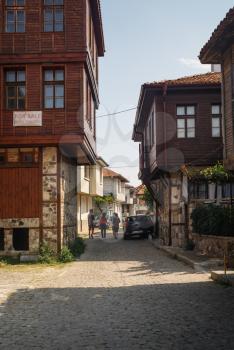 Sozopol, Bulgaria - September 03, 2014: Old town of Sozopol at Black Sea, Bulgaria. Street, ancient architecture and cobbled stone pavement. Vertical shot.