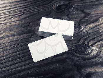 Photo of blank white business cards on wood background. For design presentations and portfolios. Mock-up for branding identity. Top view.