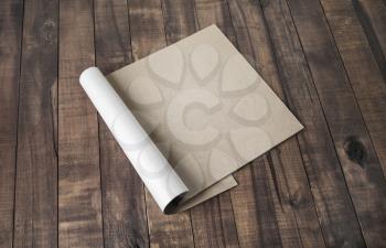 Blank notepad or brochure of kraft paper on vintage wooden background. Mockup for your design.