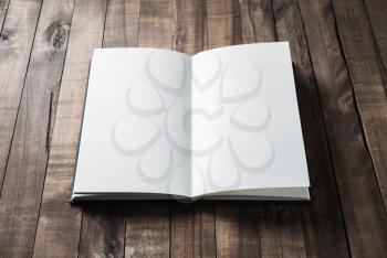 Open book, brochure or notebook with blank pages on wood table background.