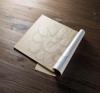 Blank open brochure or magazine on wood table background. Responsive design mockup.
