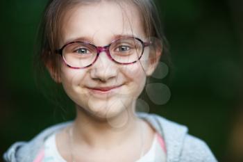 Happy smiling child girl in glasses. Selective focus.