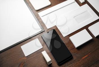 Blank corporate stationery for branding design. White ID set on wood table background.