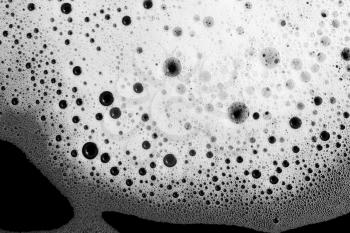 Detergent foam background. Soap foam with bubbles on black. Flat lay.