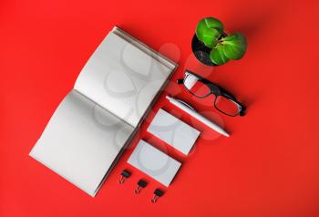 Blank stationery set on red paper background. Template for branding identity. For graphic designers presentations and portfolios. Flat lay.