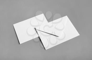 Blank paper envelopes on gray paper background. Back and front. Mockup for your design.